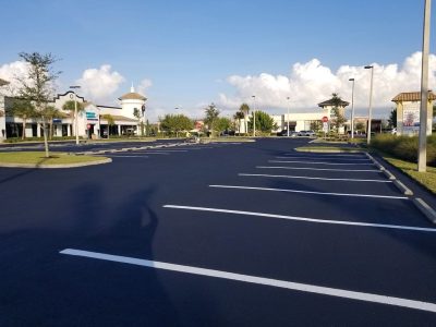 sealcoating and striping guide to asphalt surfaces - naples florida parking lot with sealcoated asphalt surphase